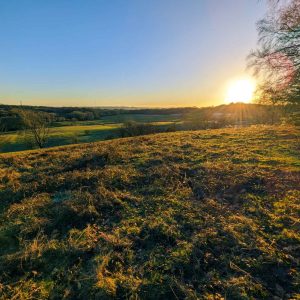 Sun setting over fields