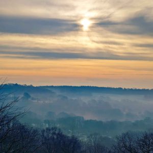 Misty hills with orange sky