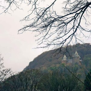 Castell Coch behind bare tree branches