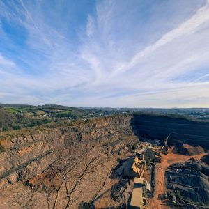 Open quarry with buildings and machinery